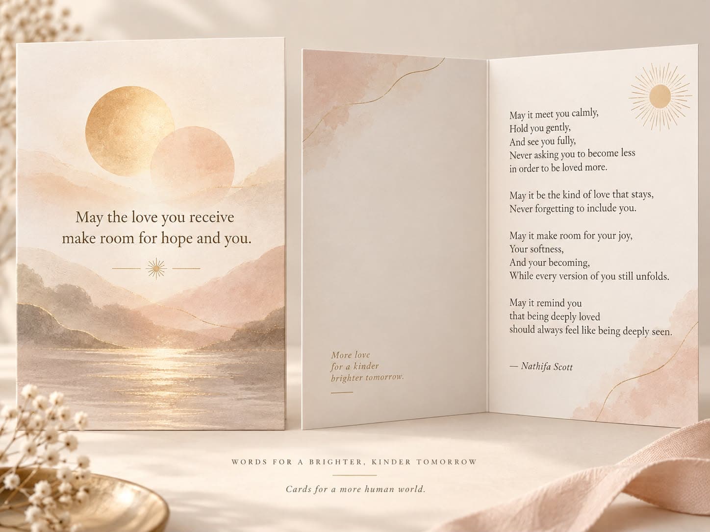 Watercolor card with a gold sun over pink mountains and a lake, shown open beside its inside poem.